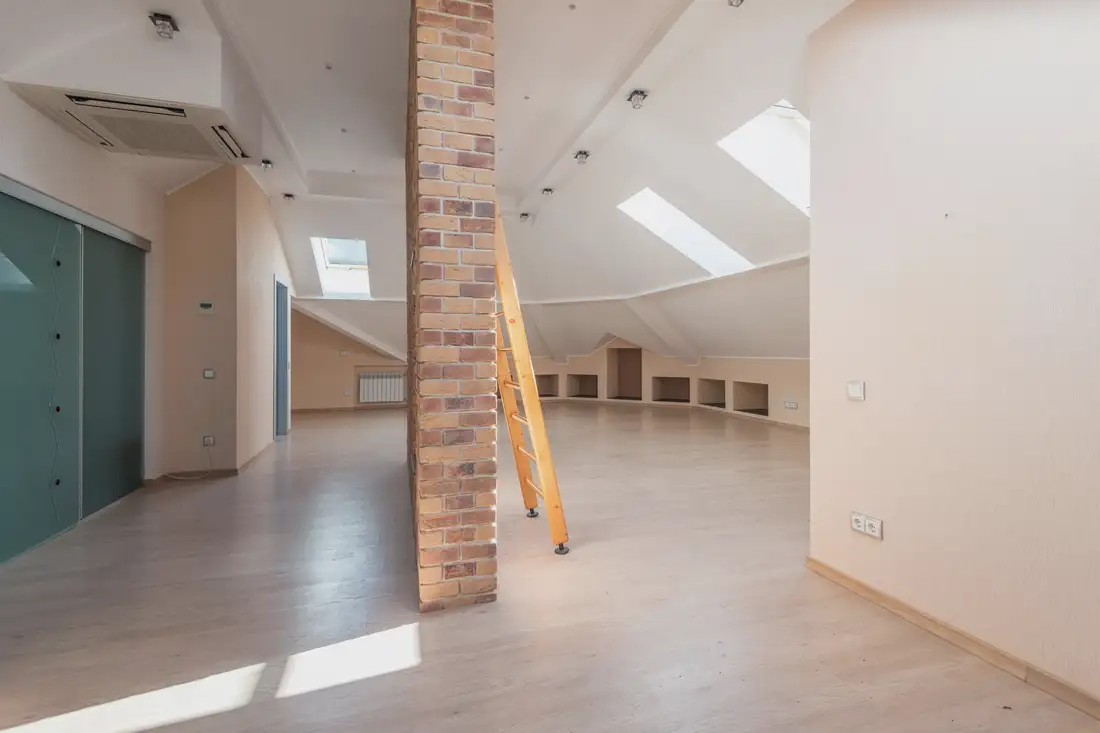 Finished attic room with skylights and a brick chimney