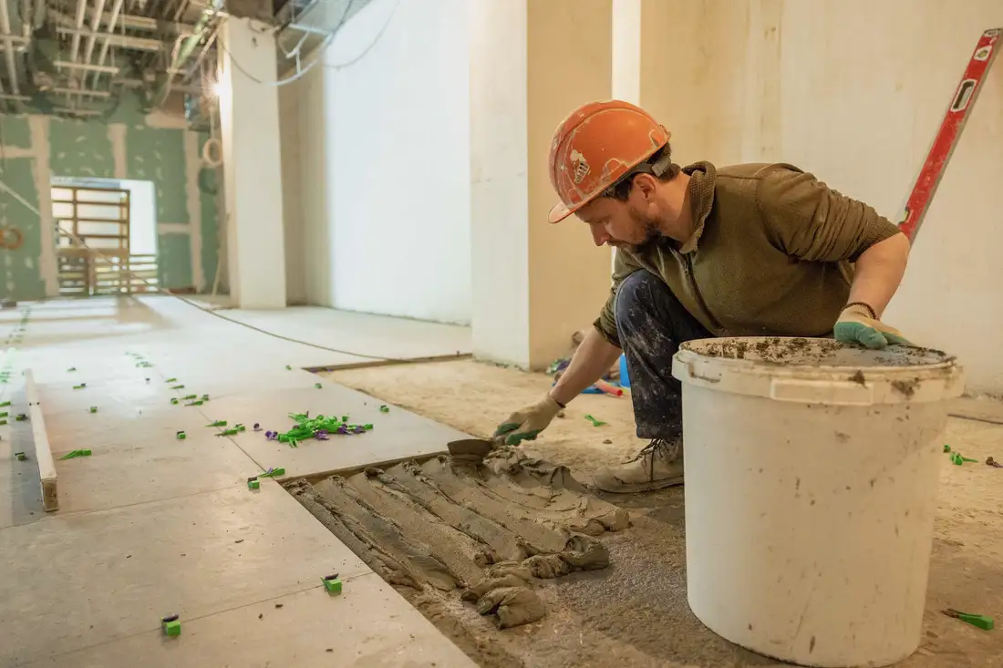 Tile setter laying floor tile