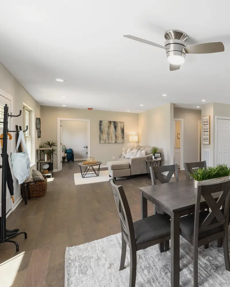 Open living, dining and kitchen space with wood floors after a whole-home remodel